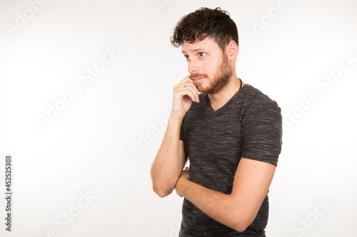 young caucasian man dark sad with beard looking at camera