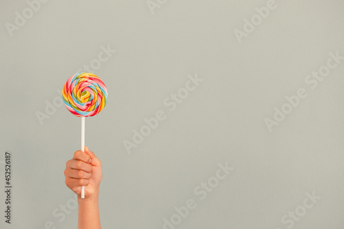 Lollipop held by a hand with copy space 