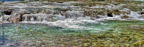 At the creek with crystal clear water on a hot summer day