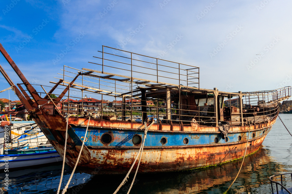 Old rusty and abandoned ship in a port in Nessebar, Bulgaria Old rusty and abandoned ship in a port in Nessebar, Bulgaria