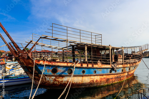 Old rusty and abandoned ship in a port in Nessebar, Bulgaria