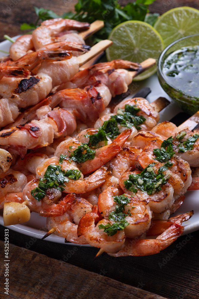 Seafood: shrimp in bacon and shrimp with garlic and herbs on skewers