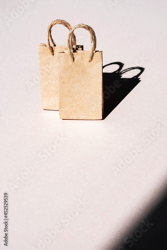 Mockup recycled paper craft shopping bags, on light background, copy space. Sales or shopping concept.