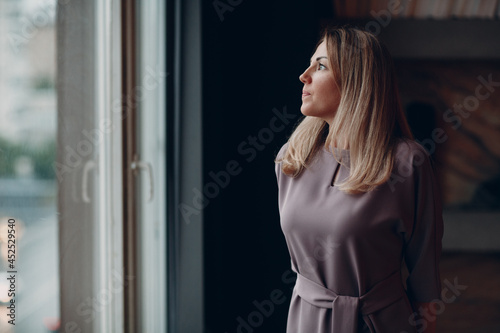 Business woman young adult coach standing at office window