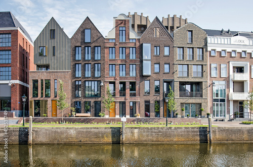 Zwolle, The Netherlands, August 20, 2021: row of recently built canal houses with yearstone 2020, inspired by traditional architectural styles