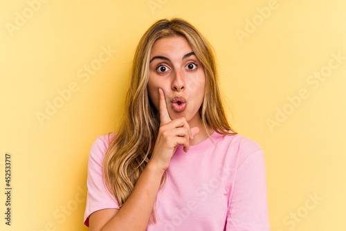 Young caucasian blonde woman isolated on yellow background having some great idea, concept of creativity.