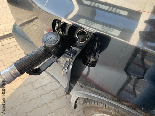 Pumping gasoline fuel in car at gas station.concept Travel and transportation.

