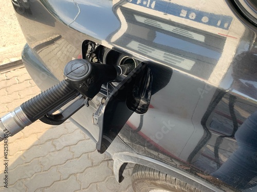 Pumping gasoline fuel in car at gas station.concept Travel and transportation.
