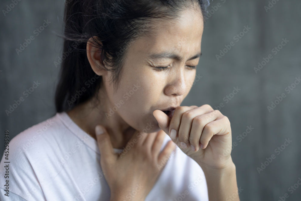 close up young asian woman Cough, sneeze and cover your mouth with your hand. close up young asian woman Cough, sneeze and cover your mouth with your hand.