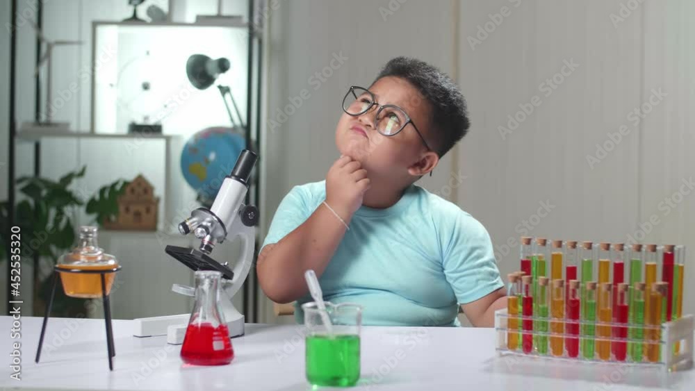Cute Little Scientist Looking At Liquid In Test Tube And Thinking
Cute Little Scientist Looking At Liquid In Test Tube And Thinking