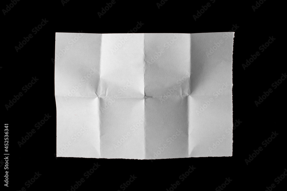 White paper sheet with bends isolated on black background. - obrazy, fototapety, plakaty 
