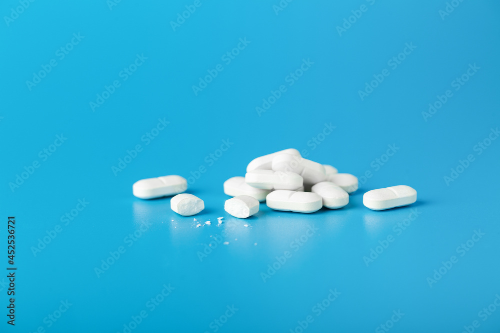 White Pills On Blue Background