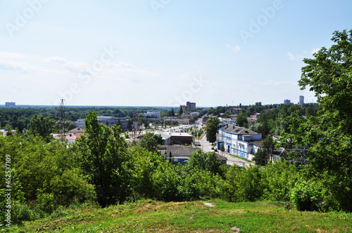 Panoramic view from the dais to the city of Bryansk. Green trees and city buildings.