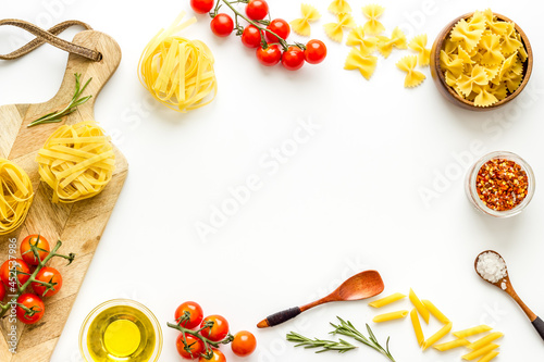 Frame of fettuccine with ingredients for cooking italian pasta