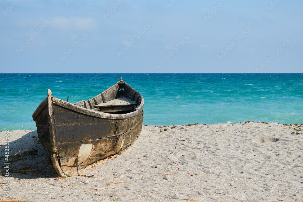 An old boat on the sand at Tuzla with the Black Sea on background