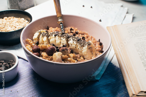 Obraz na płótnie Bowl of oatmeal porridge with banana and nuts. Top view. Healthy vegan breakfast w salonie