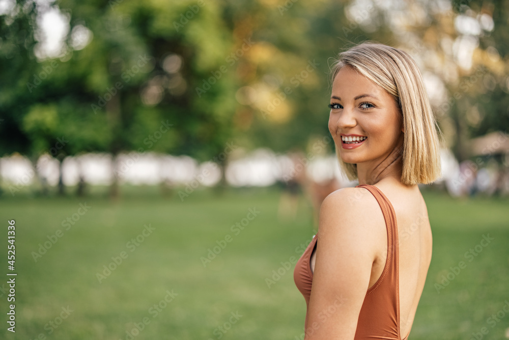 Portrait of a smiling woman in a swimsuit on a summer day, looking at camera. Portrait of a smiling woman in a swimsuit on a summer day, looking at camera.