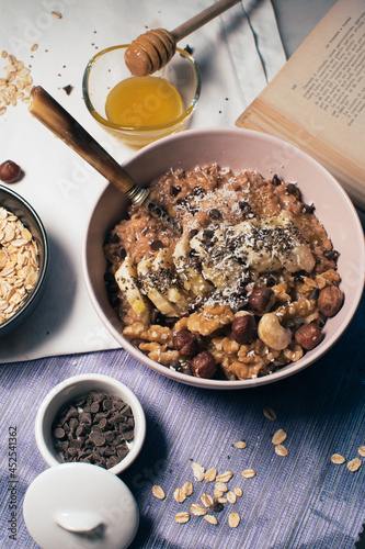 Obraz na płótnie Bowl of oatmeal porridge with banana and nuts. Top view. Healthy vegan breakfast w salonie