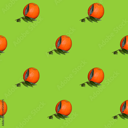 Pattern of Fresh orange citrus fruit with leaf isolated on green background.