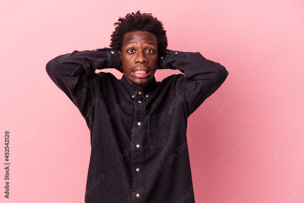 Young african american man isolated on pink background screaming with rage. Young african american man isolated on pink background screaming with rage.