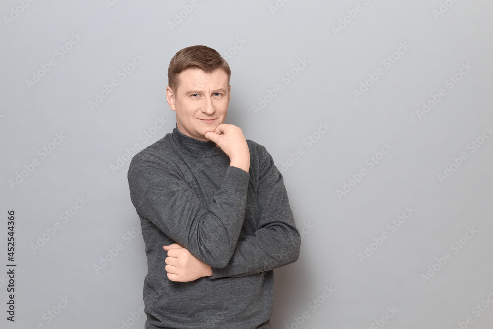 Portrait of happy mature man propping head with hand and smiling Portrait of happy mature man propping head with hand and smiling