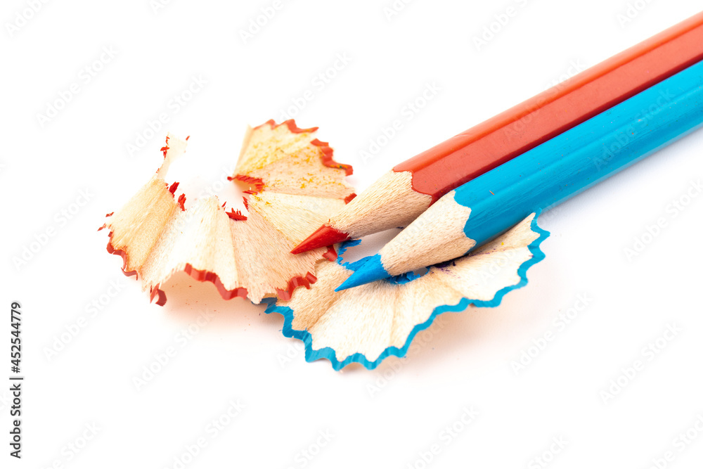 Wooden pencil whith shavings and colorful crumbs of graphite from sharpener. Back to school concept. Wooden pencil whith shavings and colorful crumbs of graphite from sharpener. Back to school concept.