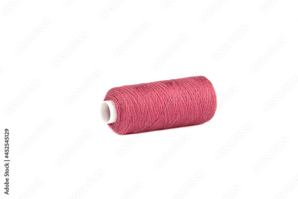 Overlock spool with red threads isolated on white background. Overlock spool with red threads isolated on white background.