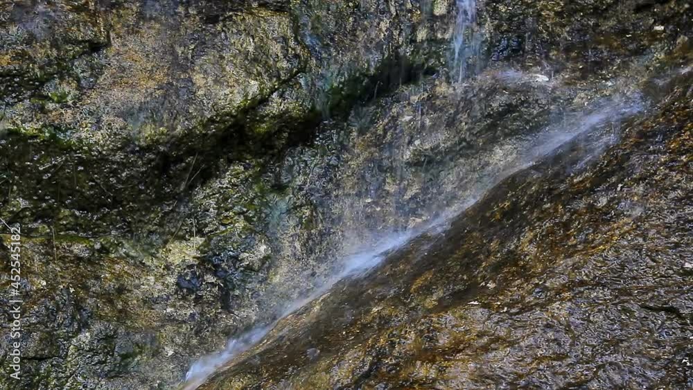 Small waterfall on large stone in Austrian Alps, klausbach river, valley near attersee Small waterfall on large stone in Austrian Alps, klausbach river, valley near attersee