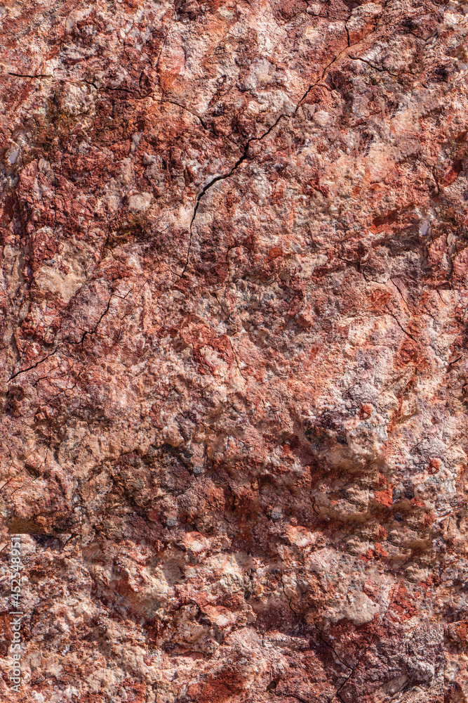 Seamless background of highly textured red vein granite rock Seamless background of highly textured red vein granite rock