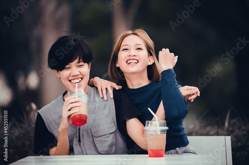 Couple of girl with girl,LGBT Pride month concept,Asian Handsome male make up and wear woman cloth,Gay Freedom Day,Portrait of Non-binary on white background photo