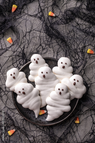 Funny and delicious meringue ghoast for halloween party decor photo