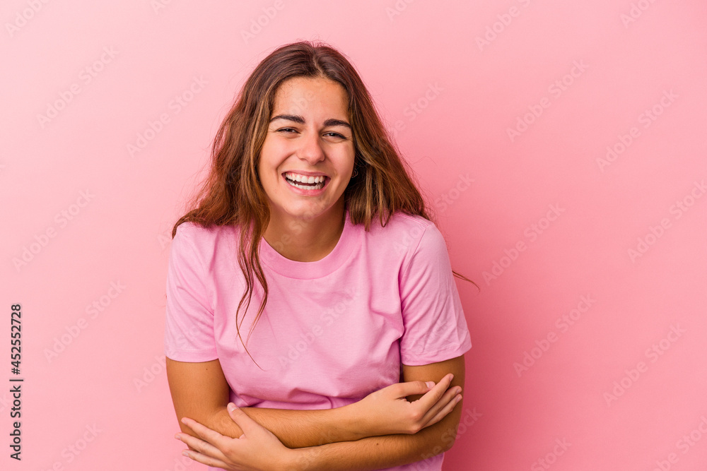 Young caucasian woman isolated on pink background laughing and having fun. Young caucasian woman isolated on pink background laughing and having fun.