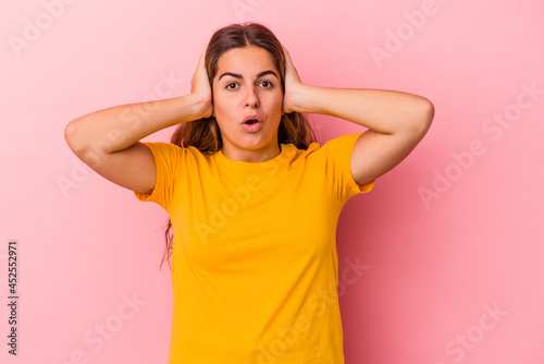 Young caucasian woman isolated on pink background  being shocked, she has remembered important meeting.