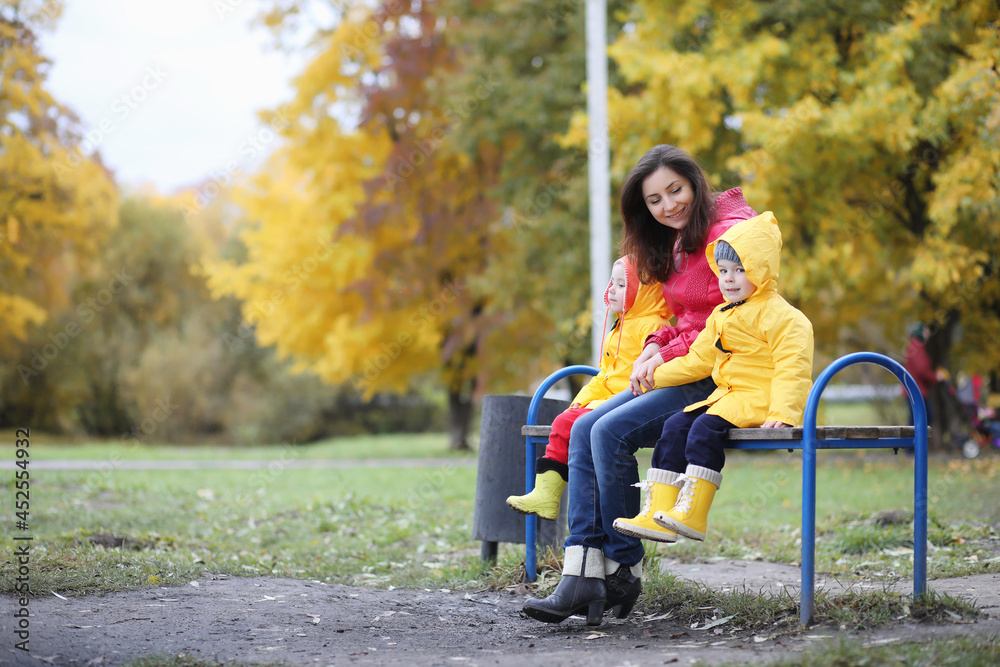 A child in a raincoat for a walk outside A child in a raincoat for a walk outside
