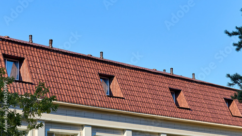 attic floor of a residential building covered with corrugated metal with windows © Temir