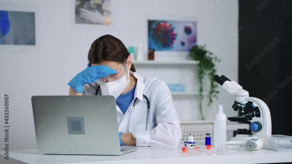 female health professional is working overtime in medical laboratory during virus outbreak female health professional is working overtime in medical laboratory during virus outbreak