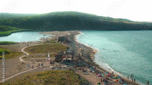 Aerial view of coast near Veleka river delta on Black sea coast, Bulgaria. Near village of Sinemorets. Sunny day. People having fun and relaxing on the beach.