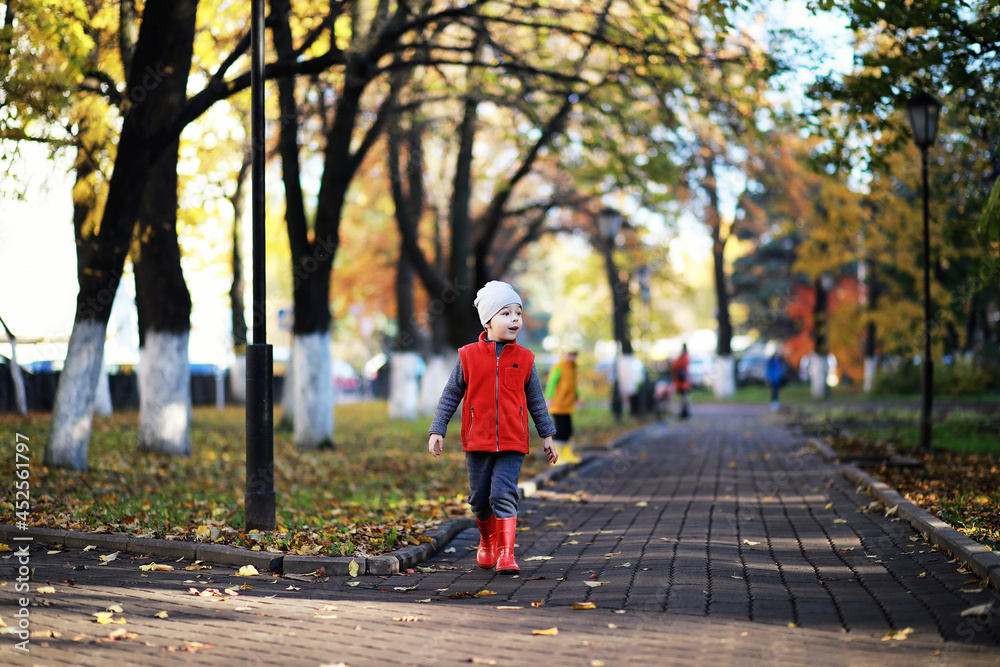 Children walk in the autumn park Children walk in the autumn park