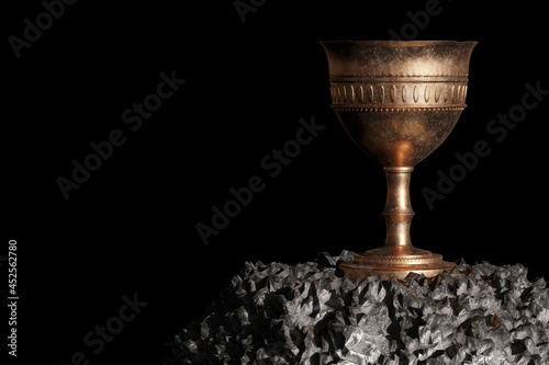 Old chalice over the stone and black background. 3D Render