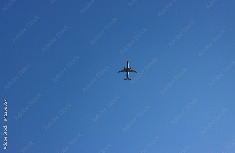 Airplane flying high in the deep blue sky Airplane flying high in the deep blue sky