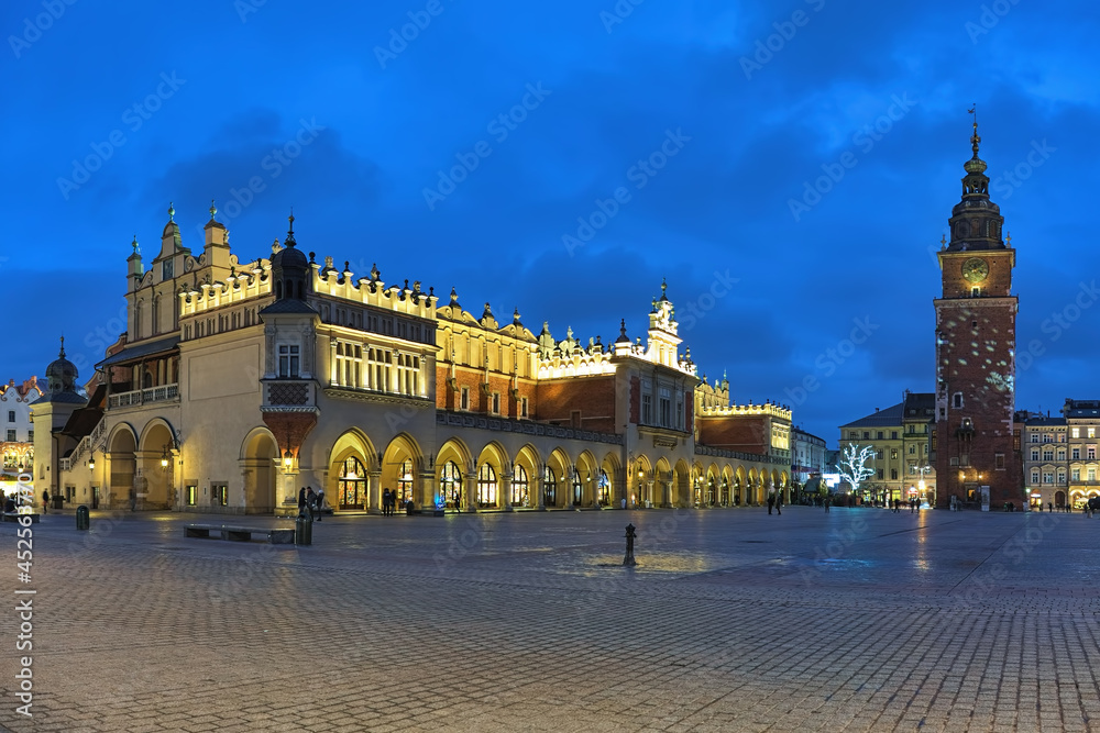 Krakow, Poland. Main Market Square (Rynek Glowny) with Cloth Hall (Sukiennice) and free-standing Town Hall Tower in Christmas illumination. Krakow, Poland. Main Market Square (Rynek Glowny) with Cloth Hall (Sukiennice) and free-standing Town Hall Tower in Christmas illumination.