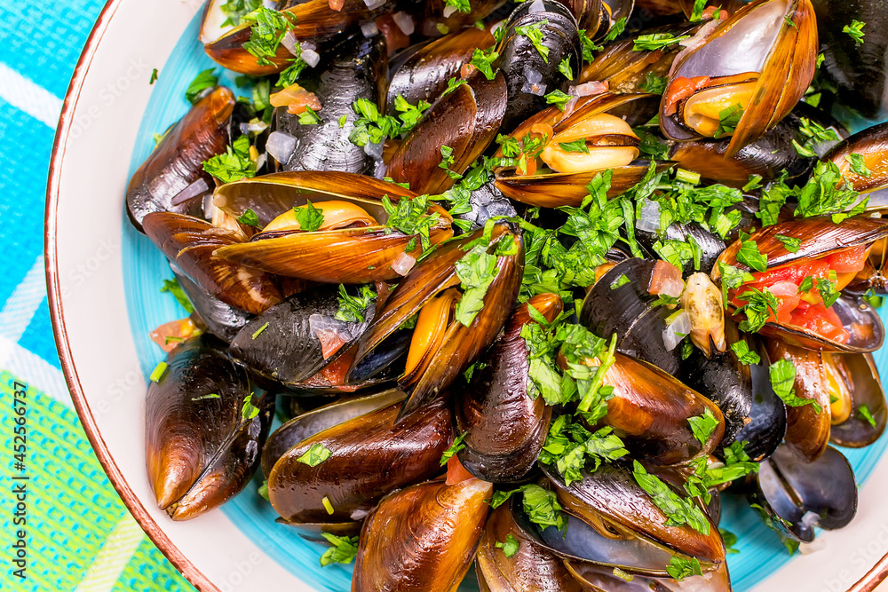 Boiled mussels with lemon and parsley in a plate Boiled mussels with lemon and parsley in a plate