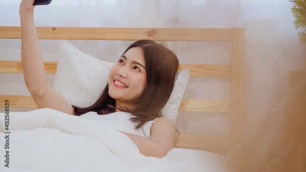 Young Asian teenager woman vlog at home, female using smartphone making vlog video to social media in bedroom. Lifestyle woman relax in morning at home concept. Young Asian teenager woman vlog at home, female using smartphone making vlog video to social media in bedroom. Lifestyle woman relax in morning at home concept.