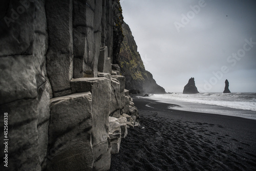 The famous Reyinisfjara black volcanic sand beach with its basalt columns an sea stacks , South Coast, Iceland photo