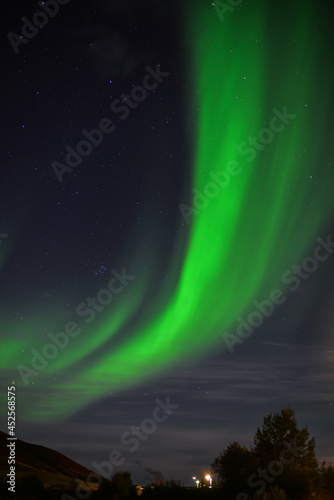 Aurora Borealis  or Northern Lights  above the village of Reykjahl      on the shore of Lake M  vatn  north Iceland