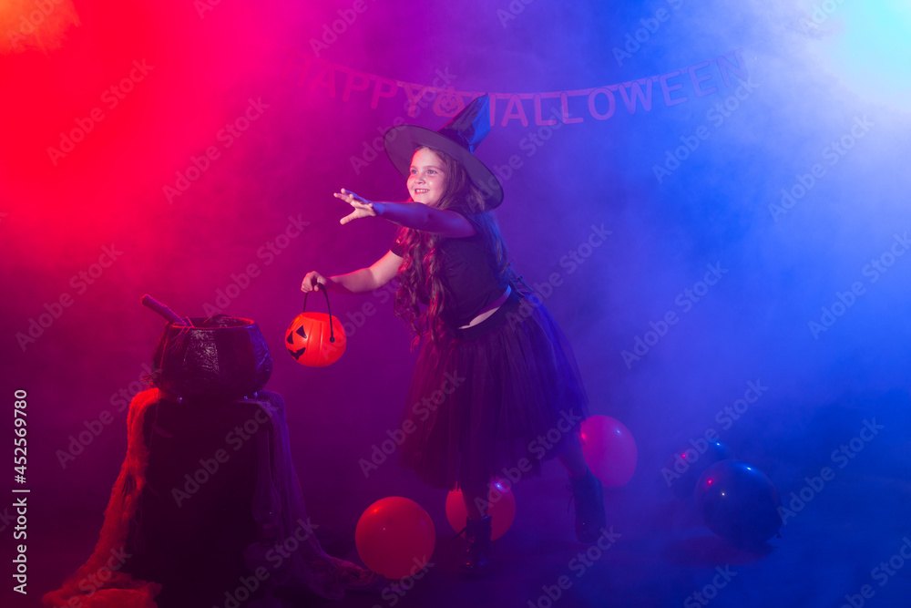 Funny child girl in witch costume for Halloween with pumpkin Jack. Funny child girl in witch costume for Halloween with pumpkin Jack.