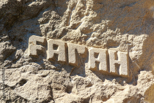 An inscription carved into an Afghan mountain or rock: FARAH. A province in western Afghanistan near the Iranian border. photo