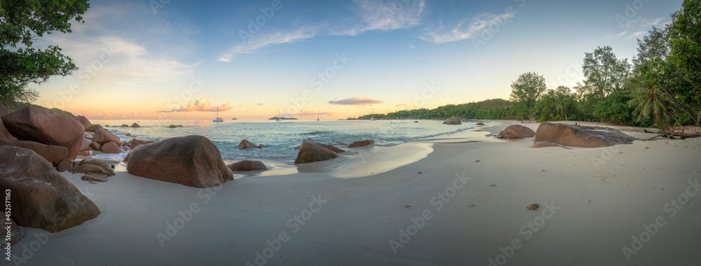 sunset at tropical beach anse lazio on praslin, seychelles