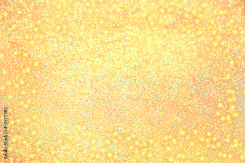 Abstract defocused yellow background with bokeh  magic glitter and blur  festive bright banner. Frame for Thanksgiving  Autumn  Halloween or Christmas Party. 
