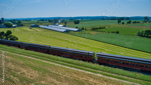 Obraz na plátne Aerial View of Restored Antique Passenger Train Coaches Travel Thru the Countrys